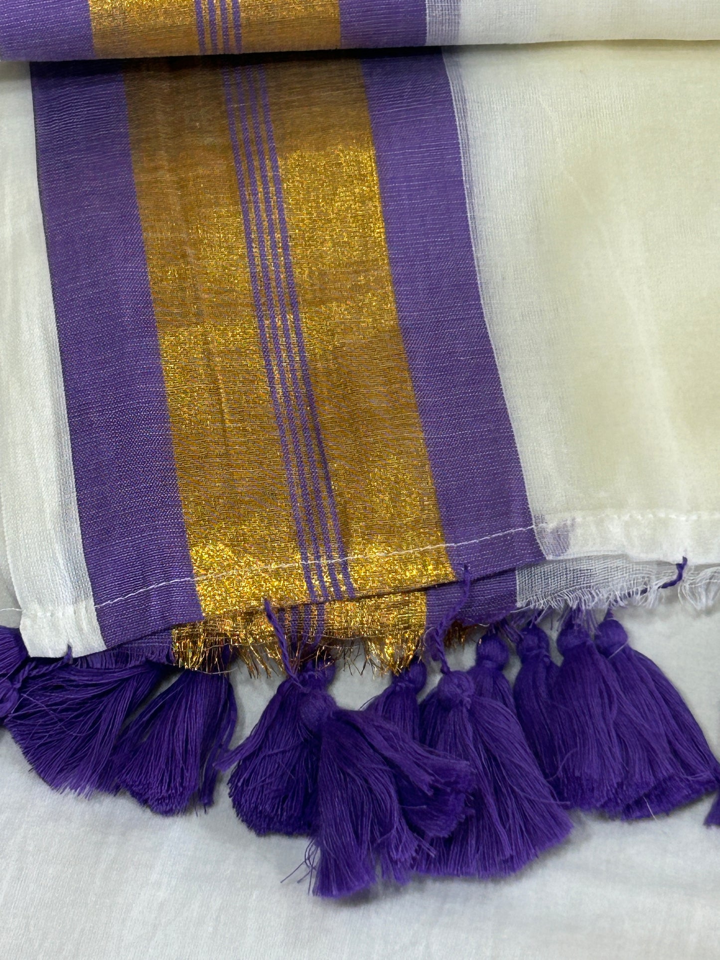 Creamish white Mulcotton saree with purple border with golden zari stripes SMC229