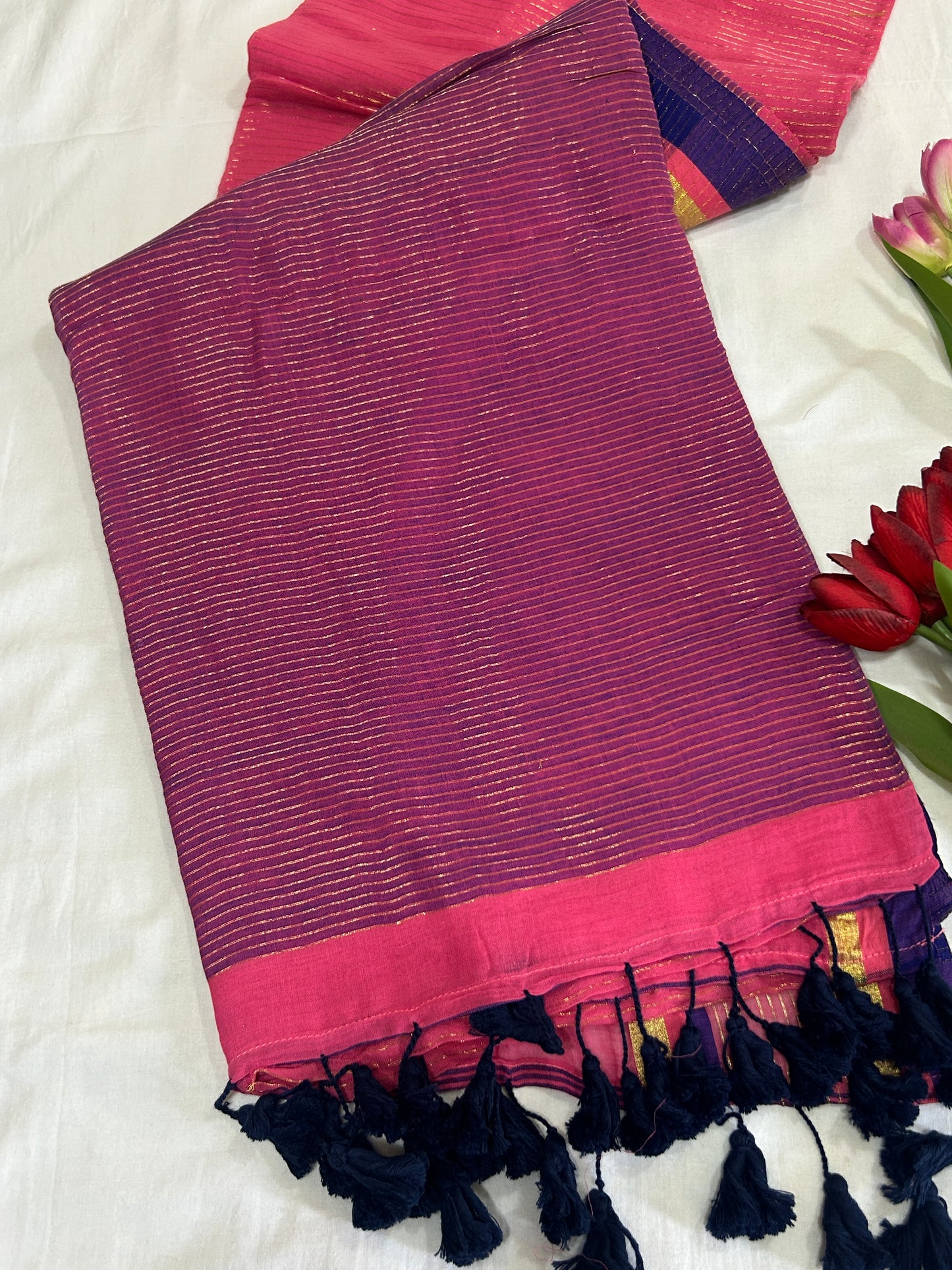 Pink color mulcotton saree with golden lines all over the body and blue and golden striped border SMC235