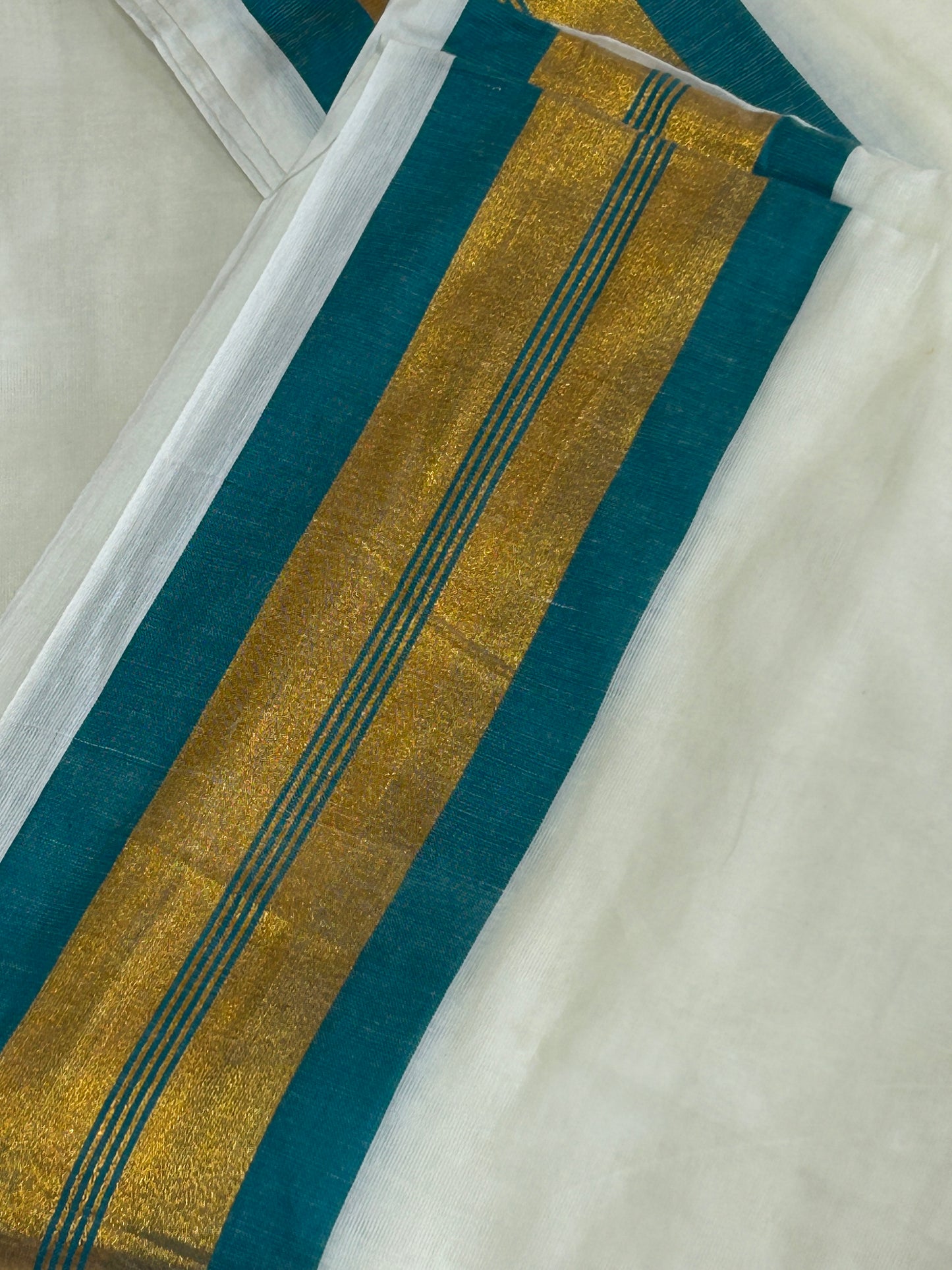 Creamish white Mulcotton saree with Teal blue border with golden zari stripes SMC227
