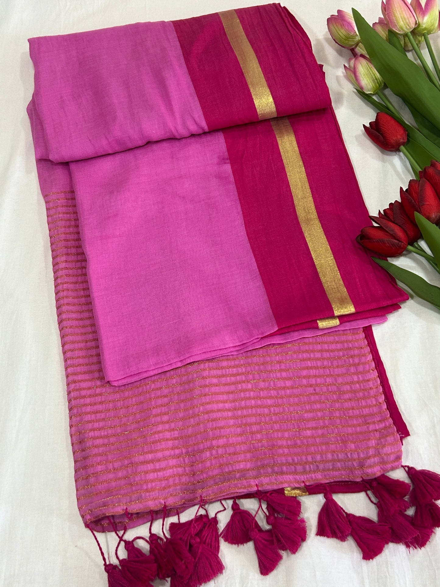 Light Pink mulcotton saree with dark pink with golden stripe border an tassels SMC236